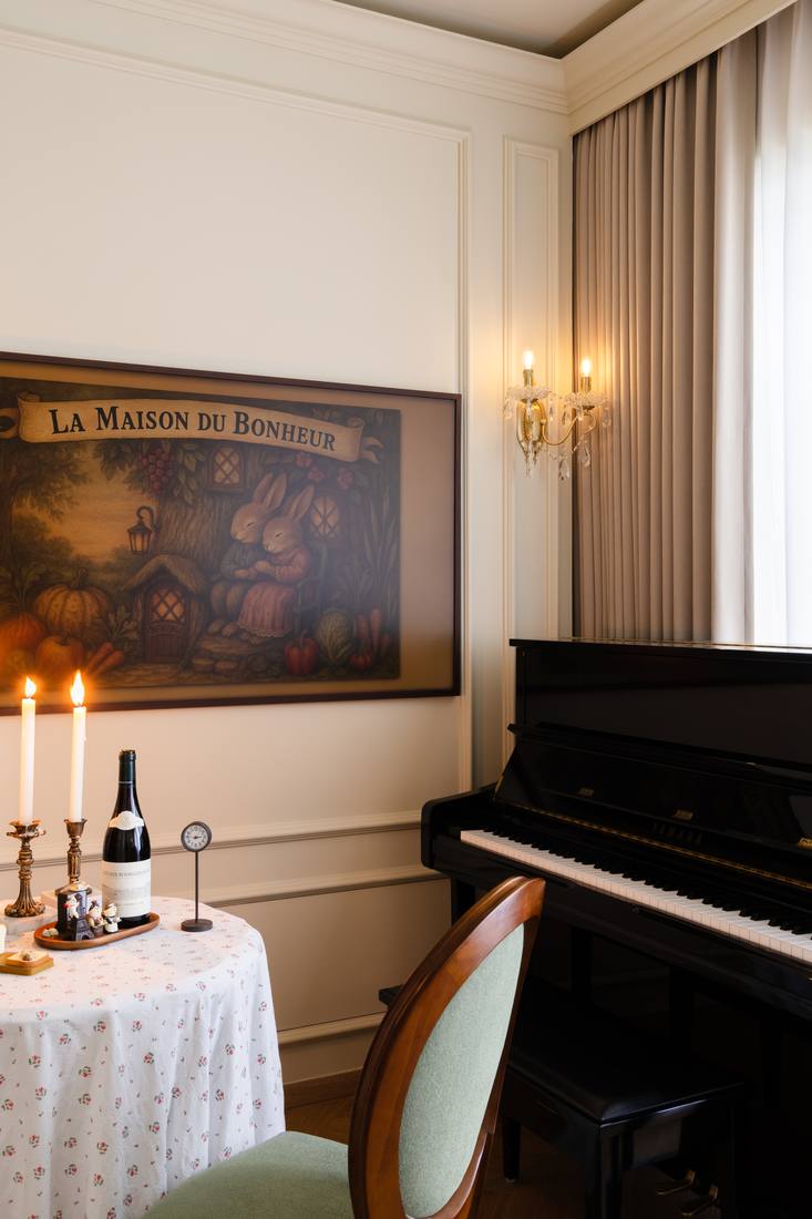 A renovated apartment interior at 57 Flora Drive — panelled walls, herringbone floor, candlelight and an upright piano