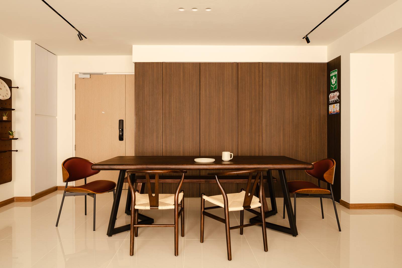 A completed renovation at 961C Tampines — walnut dining joinery, travertine and a terracotta-tiled bar niche